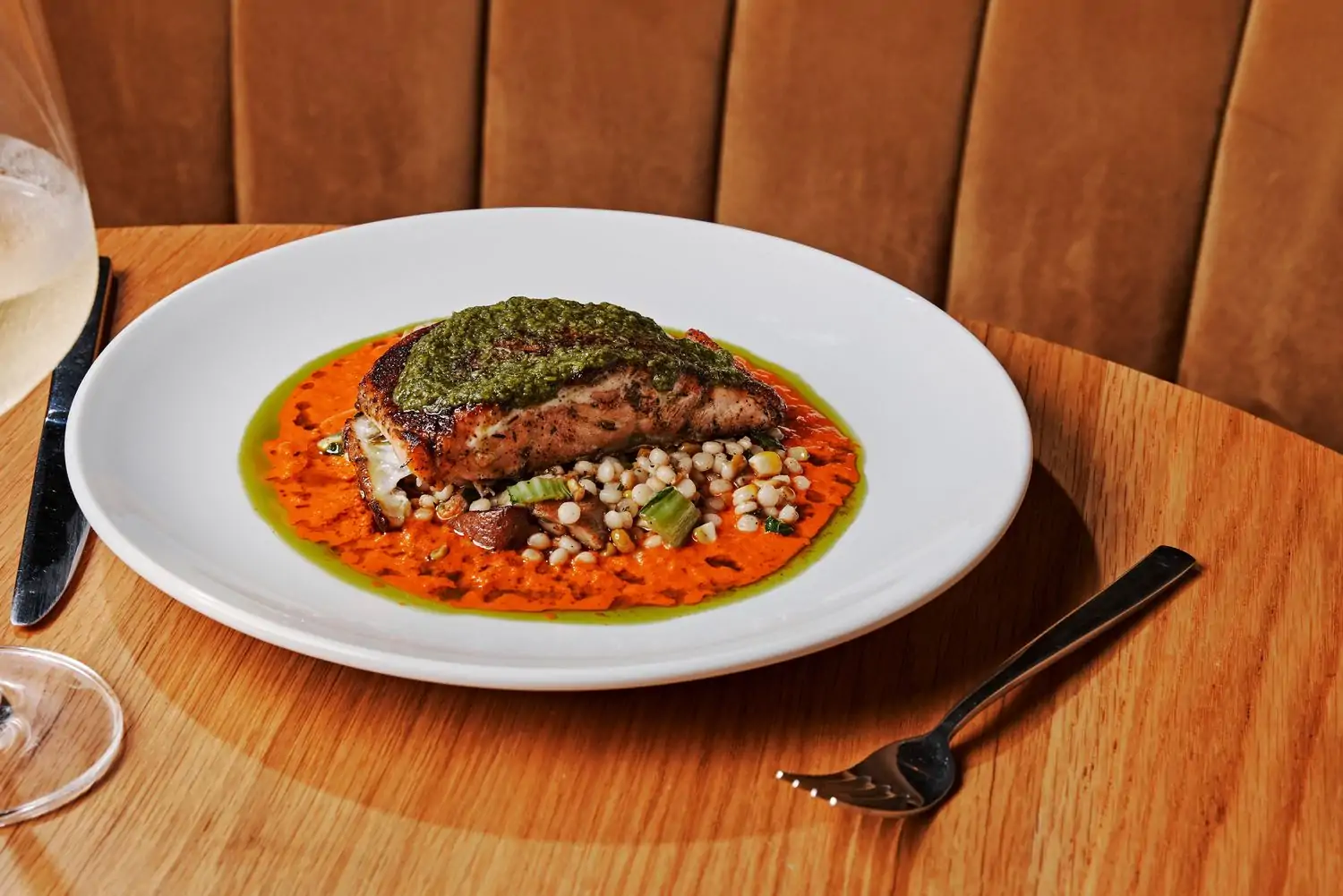 A close-up of a plate of hot honey salmon with roasted tomato cream, a specialty of Marcus Bar & Grille, one of the best Black-owned restaurants in Atlanta on OpenTable.