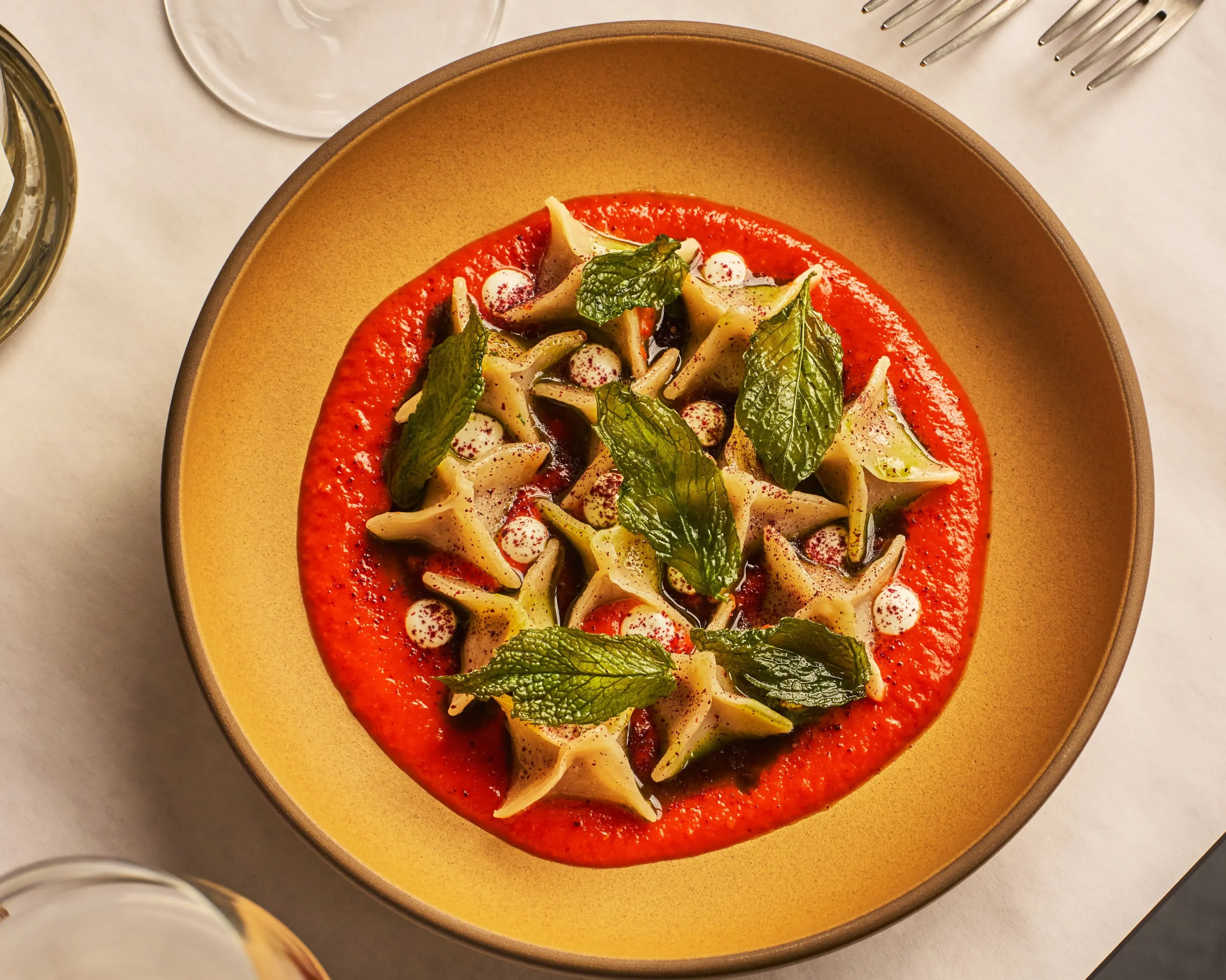 Turkish manti on a red plate Kitchen Istanbul in San Francisco, which is now a MICHELIN Bib Gourmand