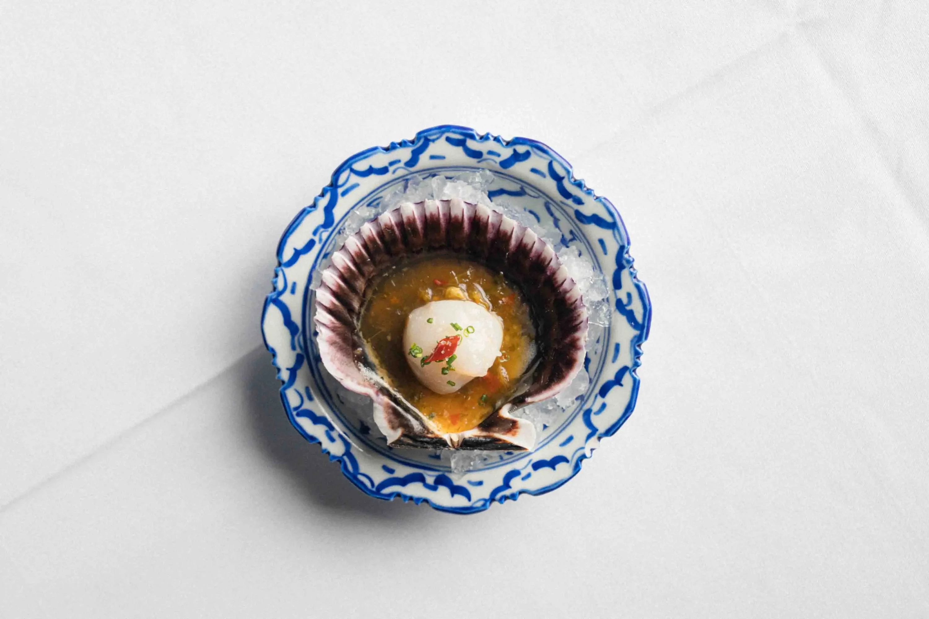 Some food placed in a clamshell at Anajak Thai, one of the best restaurants in Los Angeles