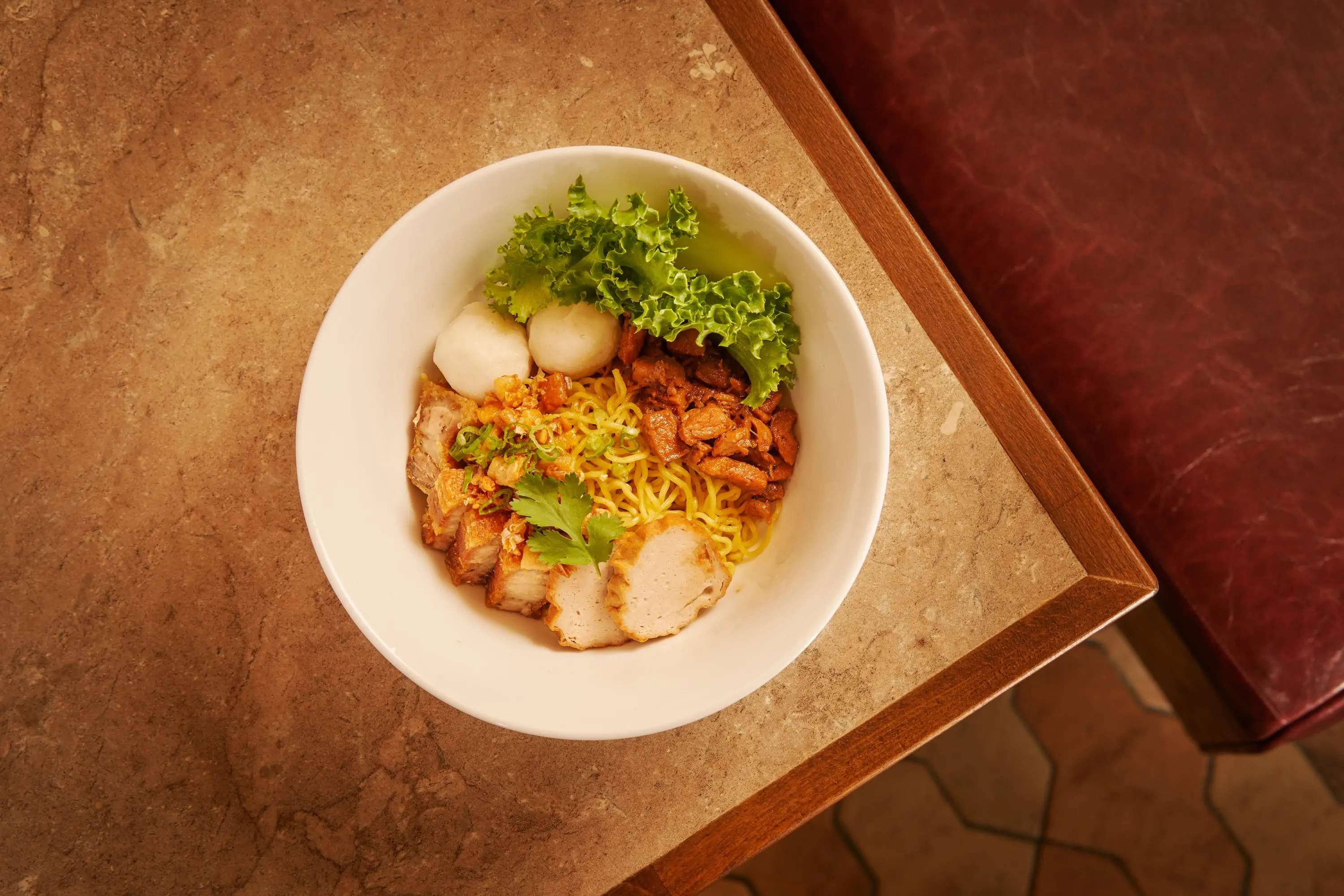 A dry noodle dish in a bowl called pok pok noodles served at Godunk in NYC
