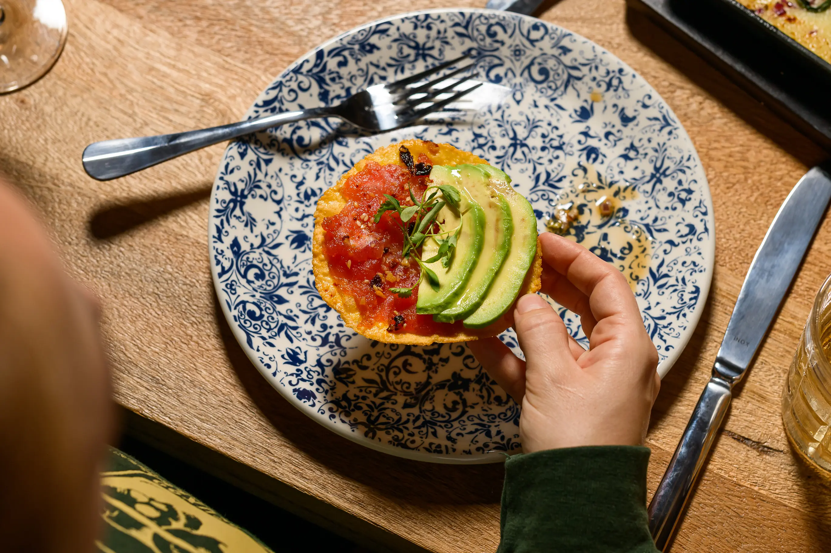 A tuna tostada with sliced avocado on top at Casa MX in Miami