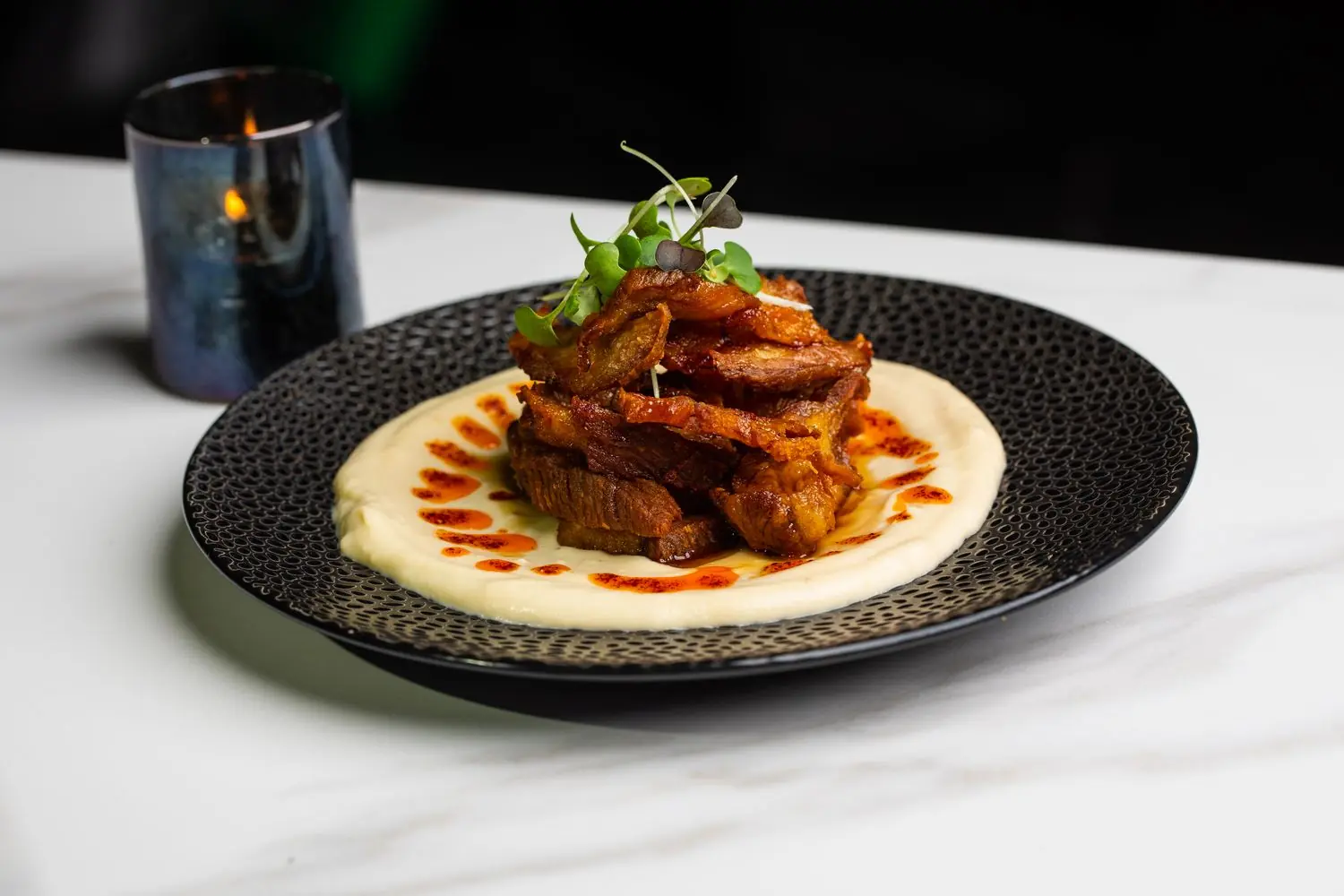 mck A crispy pork belly dish on polenta at MCK in Atlanta