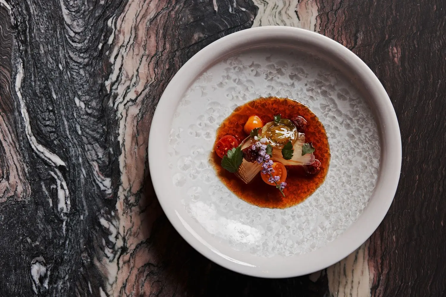 mujo A composed dish with a red liquid at Mujō in Atlanta