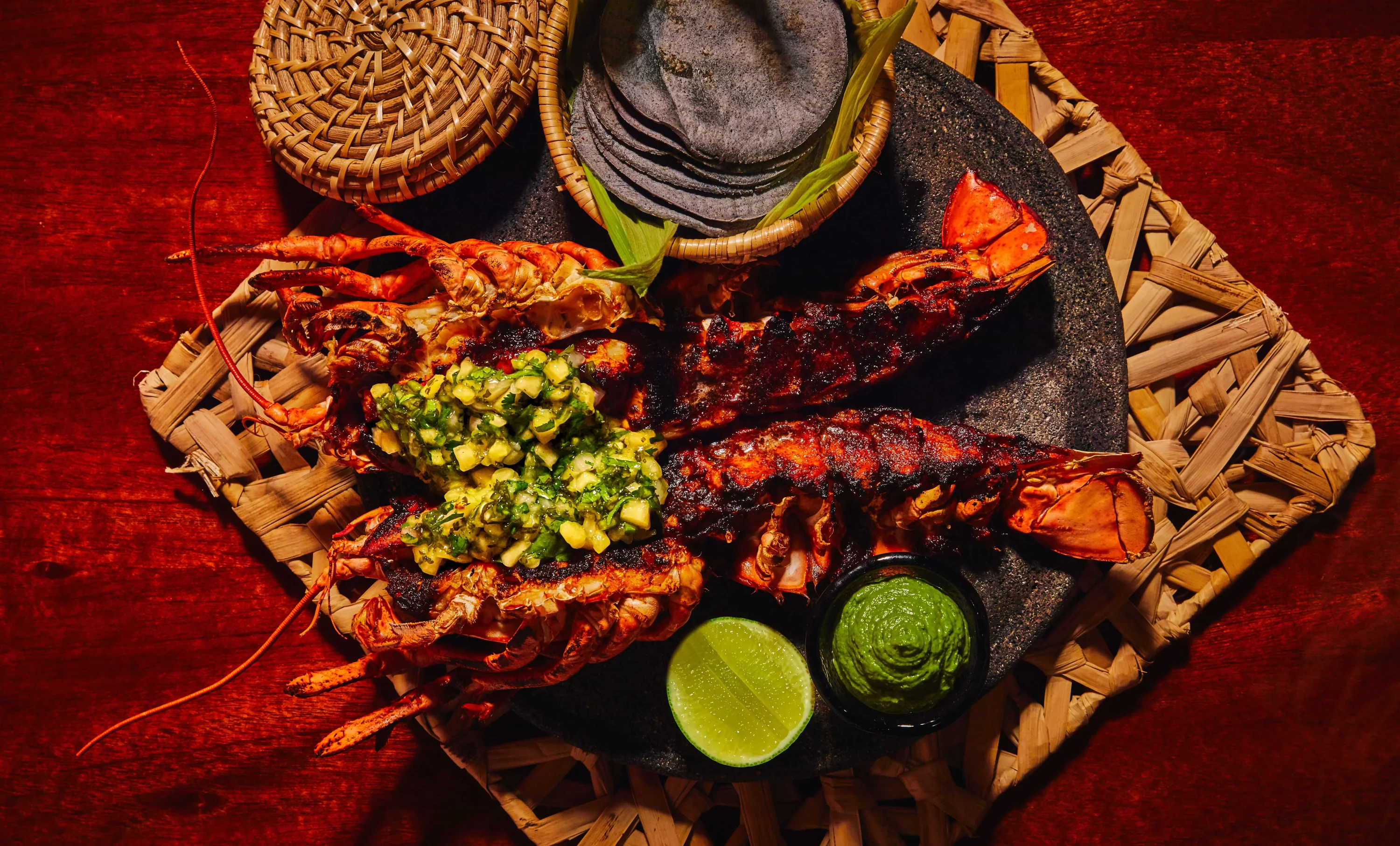 A fileted lobster with a mango salad on top at Limusina in NYC