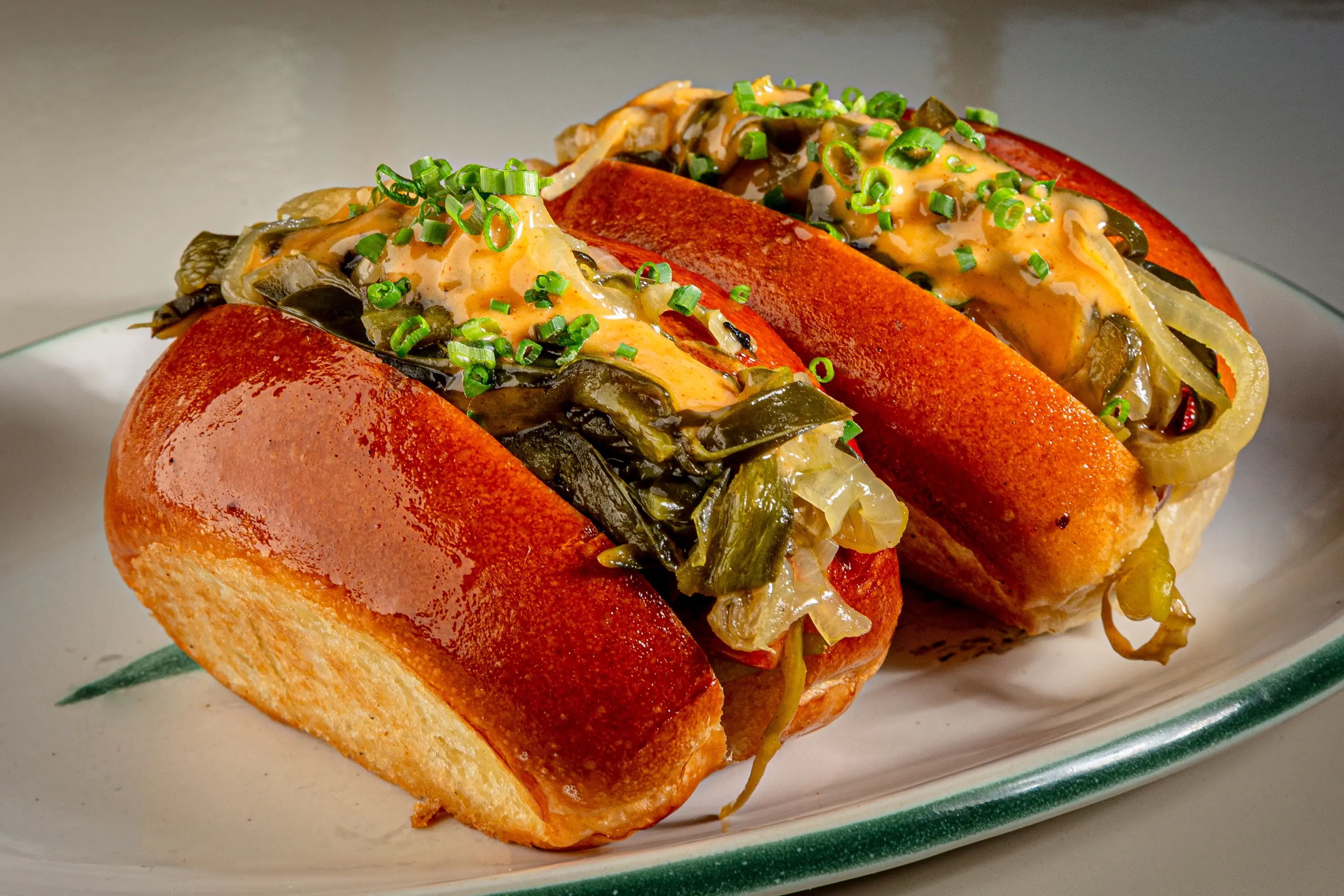 Two hot dogs sitting side by side at the restaurant Dalia in Boston