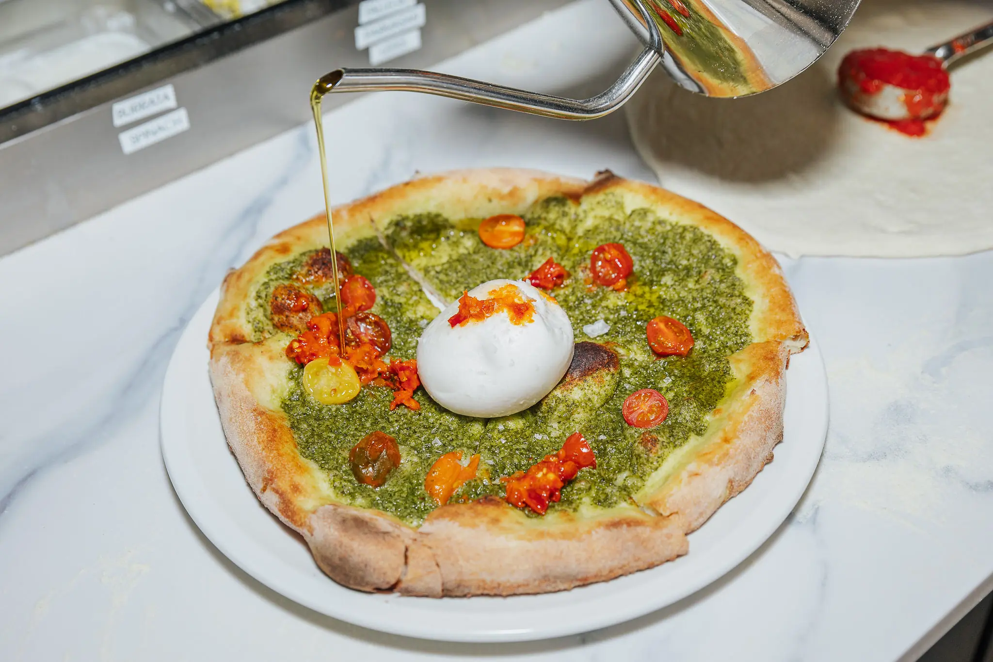 A pesto pasta with chopped tomatoes and burrata at La Bella Trattoria on Rush in Chicago