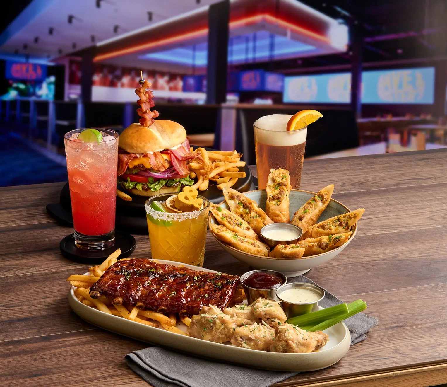 Glazed ribs, a burger with fries, and egg rolls at Dave & Buster’s in King of Prussia
