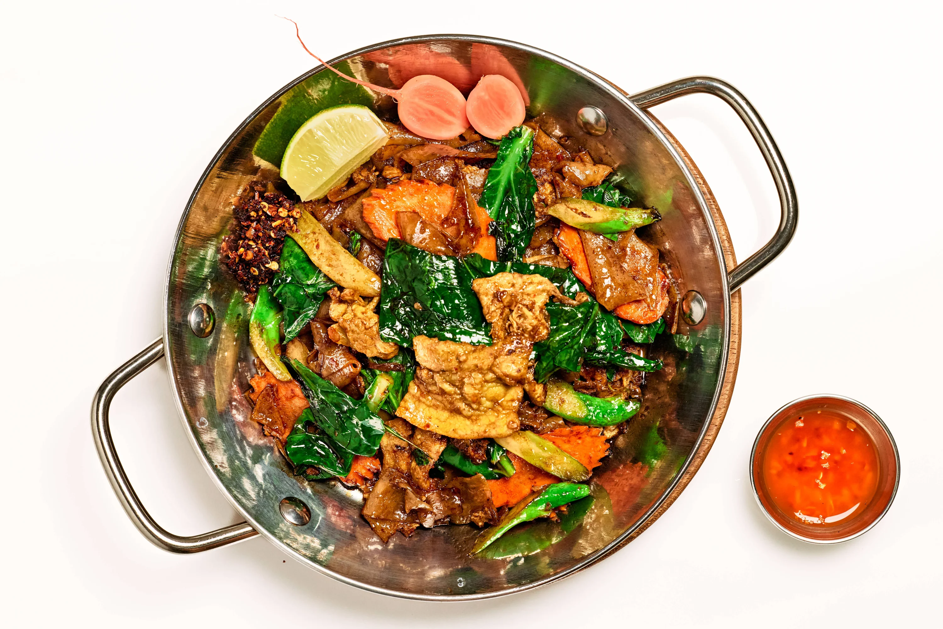 A stir-fry dish in a copper-clad vessel at the restaurant BOBO Thai in Los Angeles