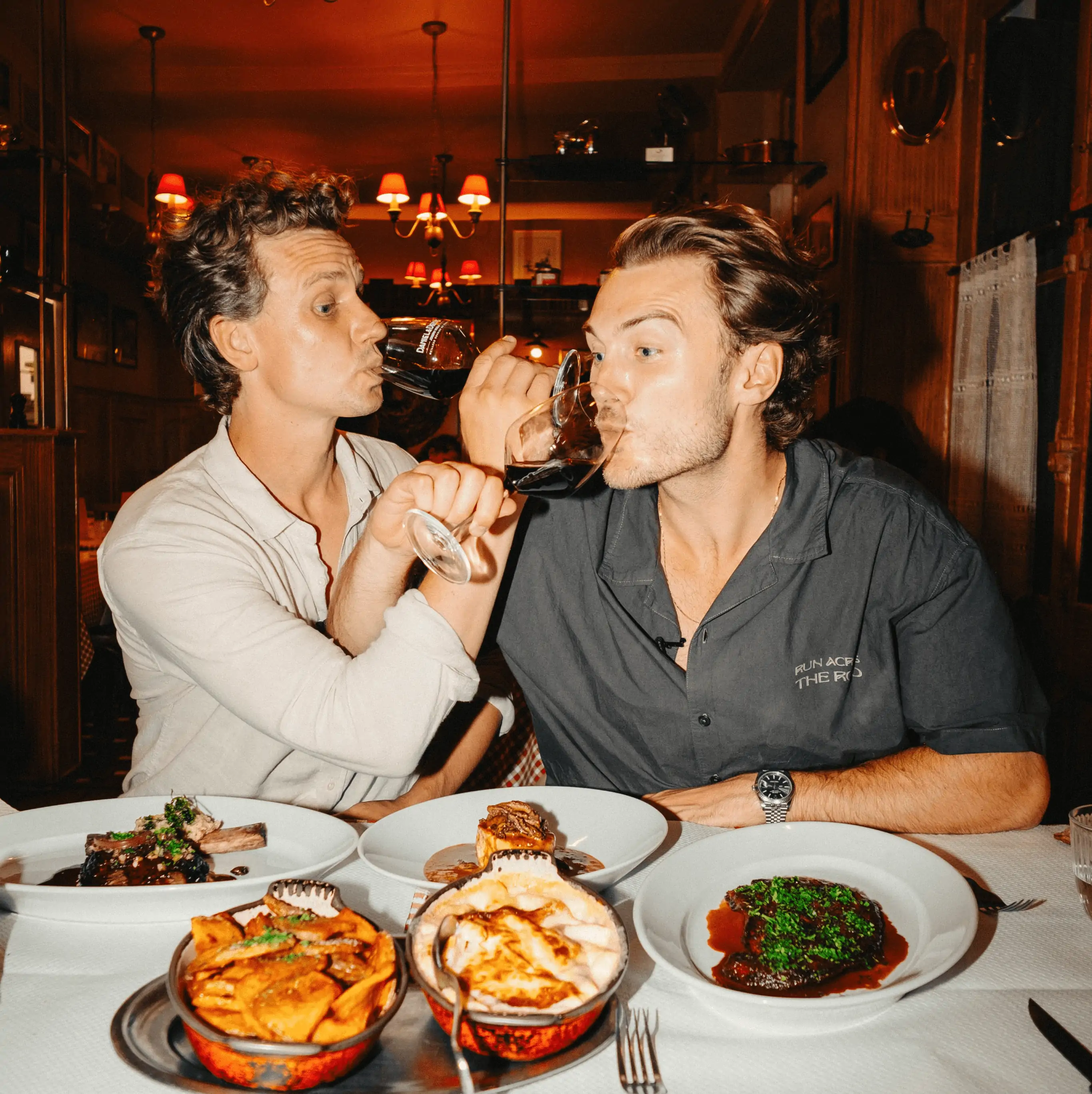 TOPJAW creators Jesse Burgess and Will Warr drinking and dining at one of the best places to eat in London West End.