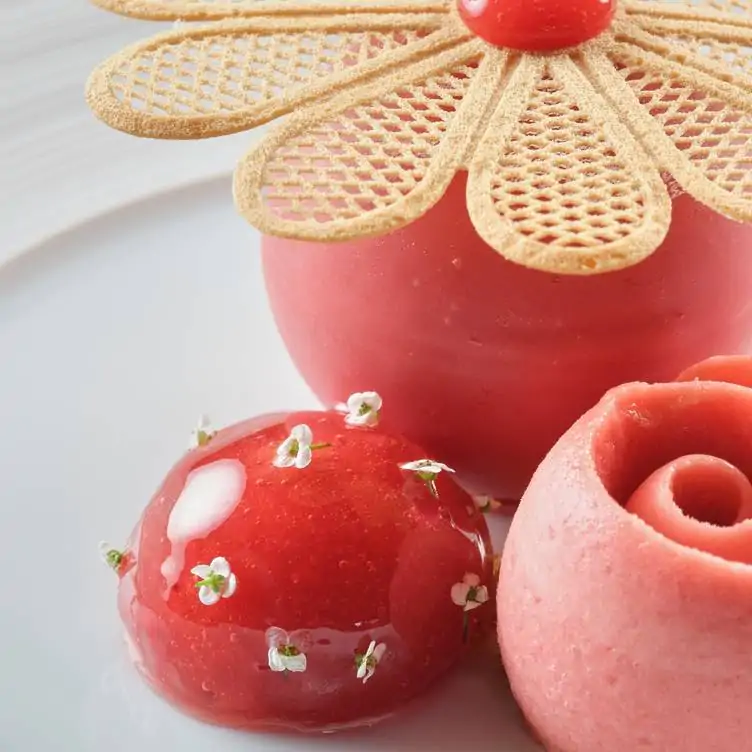 A pink-and-red dessert with flower garnishes at Clos Maggiore, one of the best spots for a pre-theatre dinner in London.