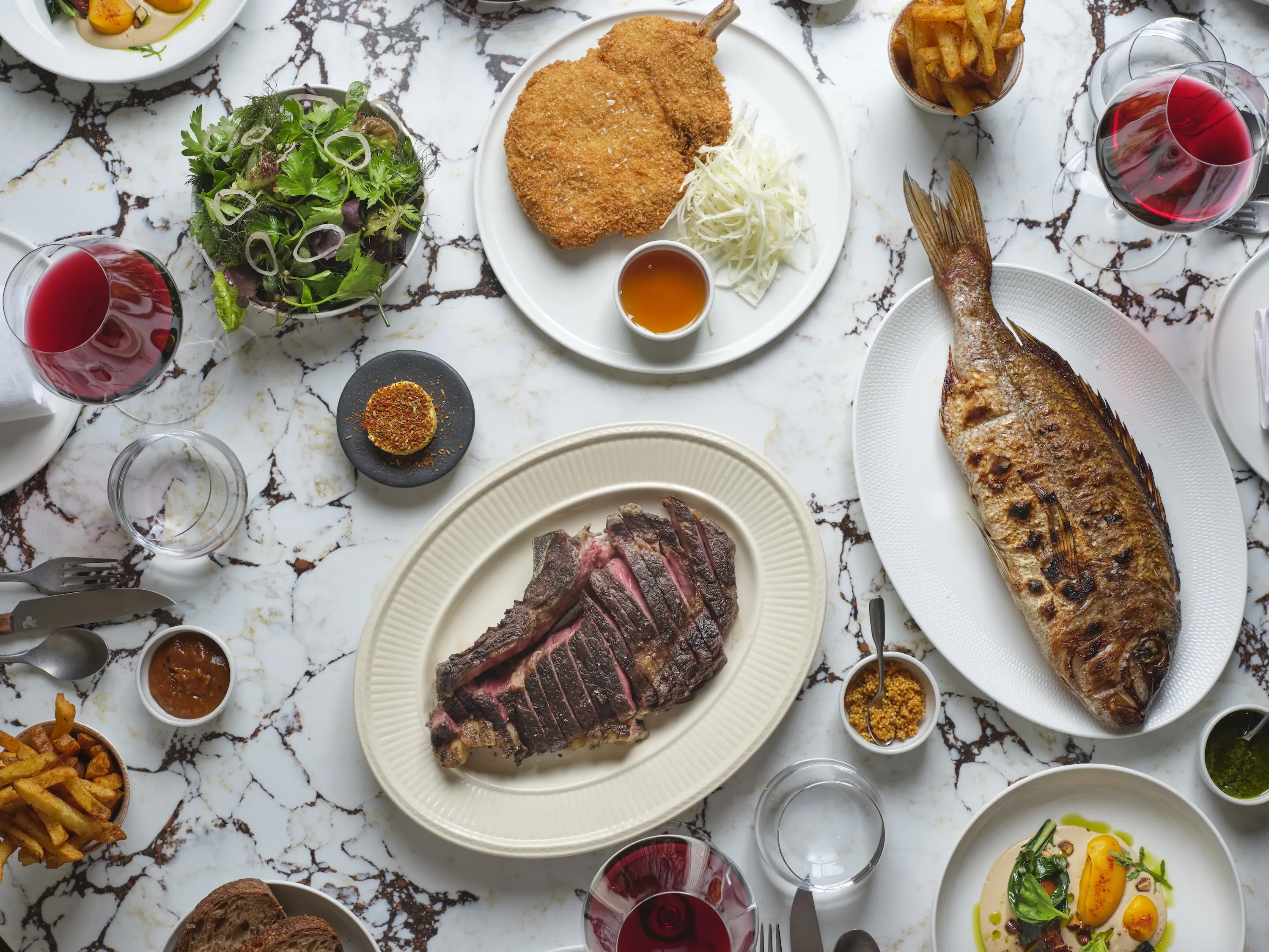 A spread of dishes on dining table at Labombe by Trivet in London