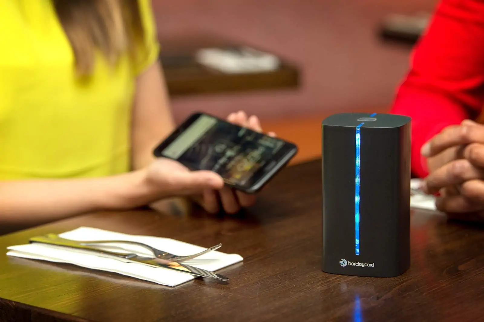 restaurant customers using tech at table